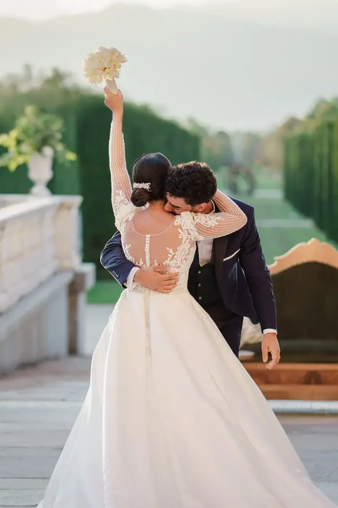 A bride and groom share a heartfelt embrace in front of the stunning Reggia di Venaria in Turin, Italy. Captured by a luxury wedding photographer in Italy, this timeless moment showcases the elegance and romance of a destination wedding in one of Italy’s most iconic locations.