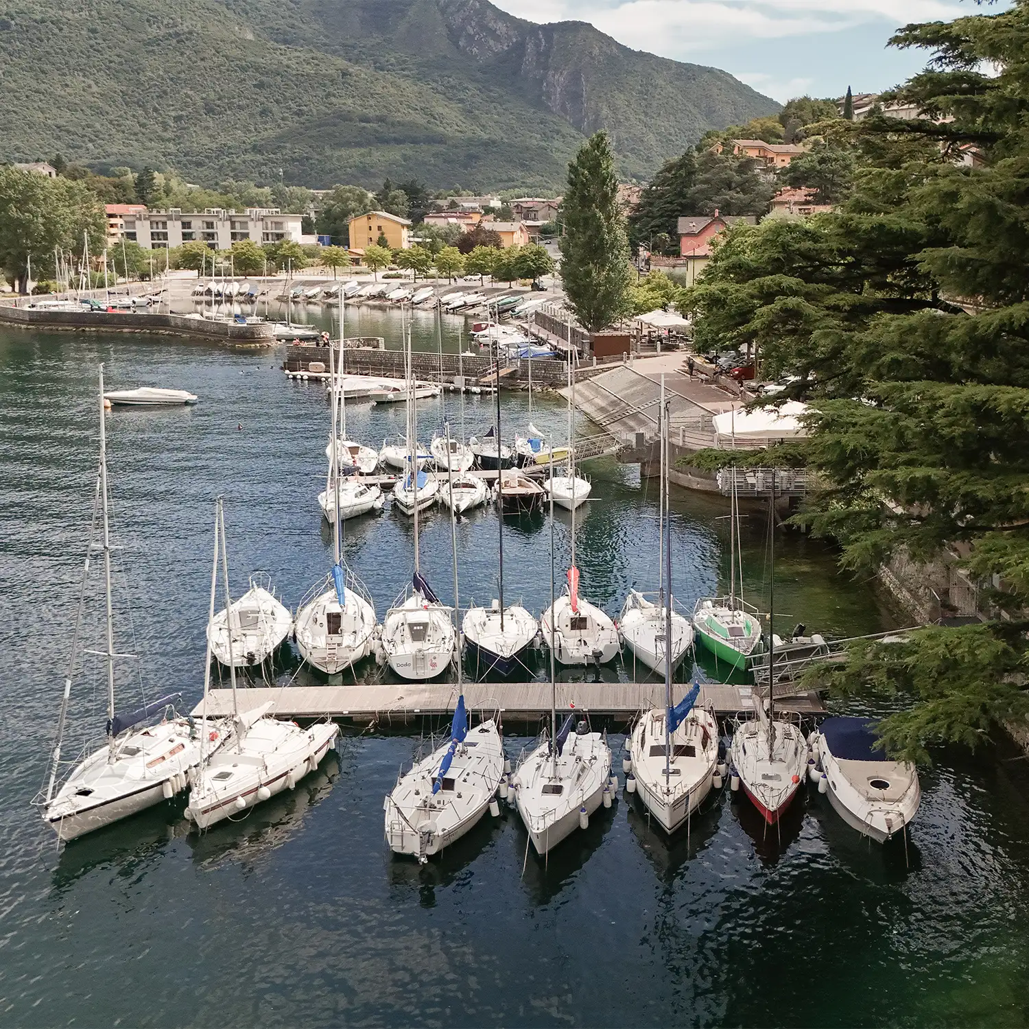 Lake Como marina with boats and mountain views near the wedding location