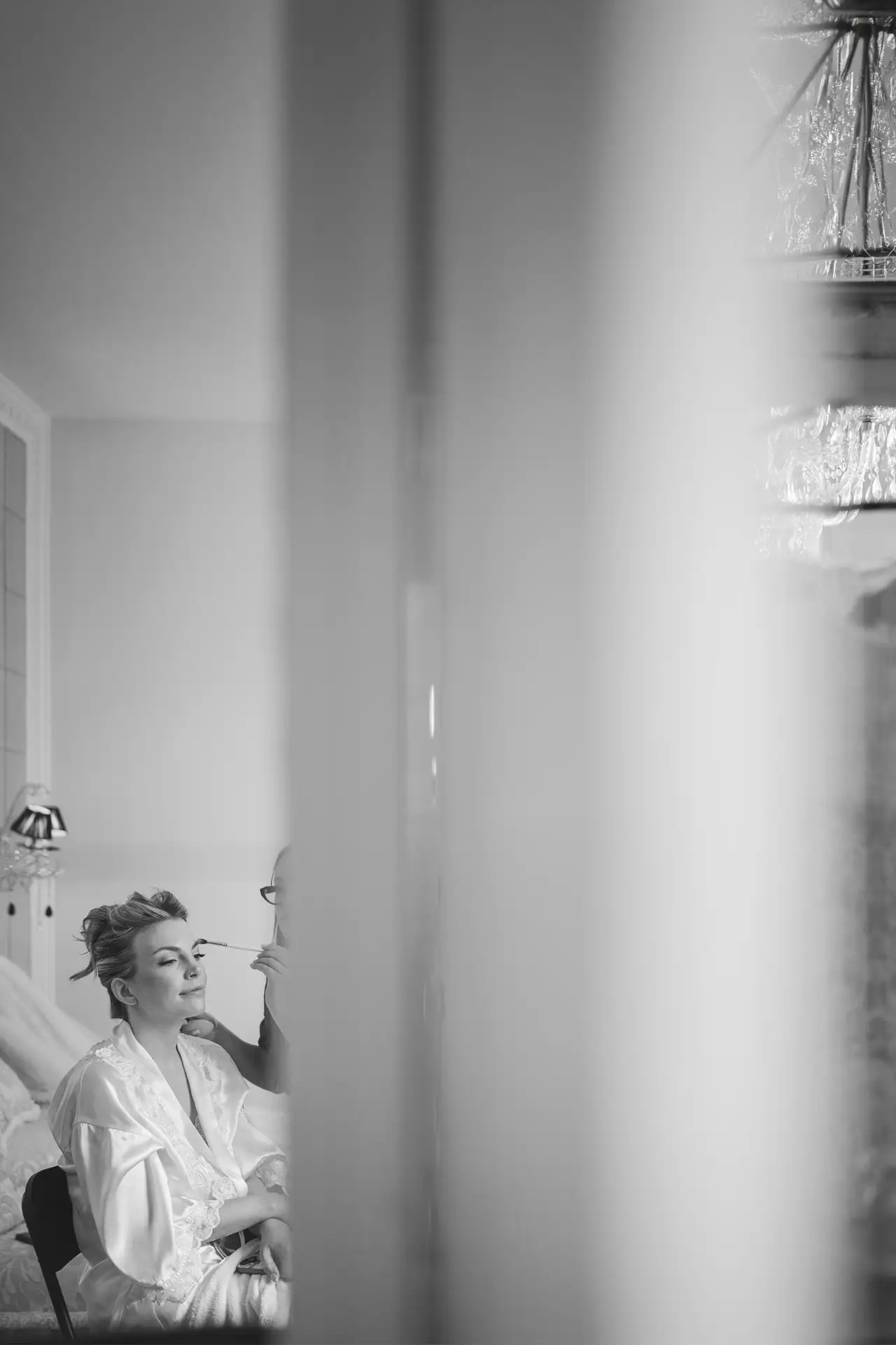 Black and white photo of the bride during makeup before a Lake Como wedding
