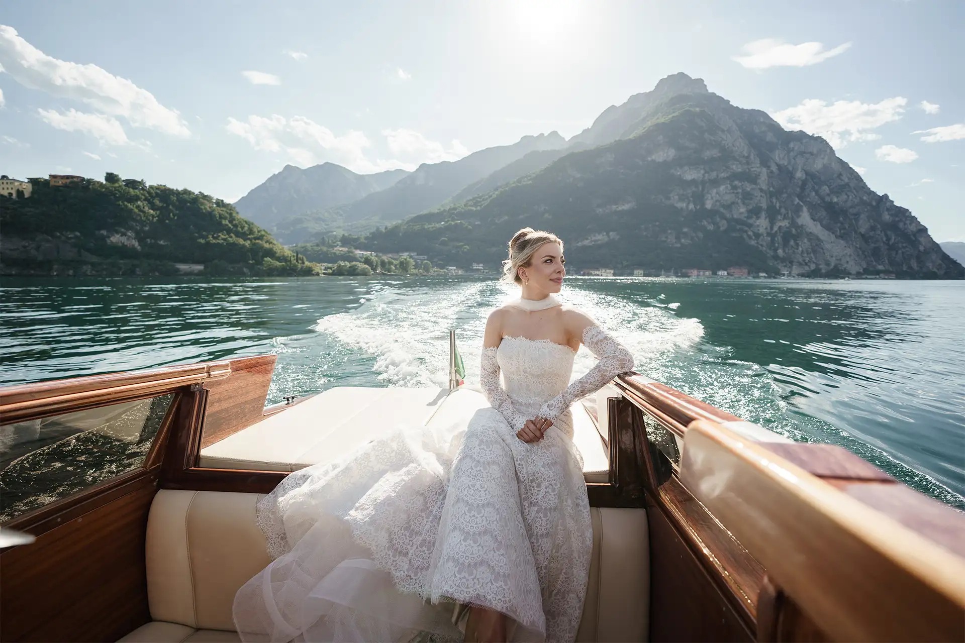 Bride sitting on a wooden boat during a Lake Como wedding portrait session