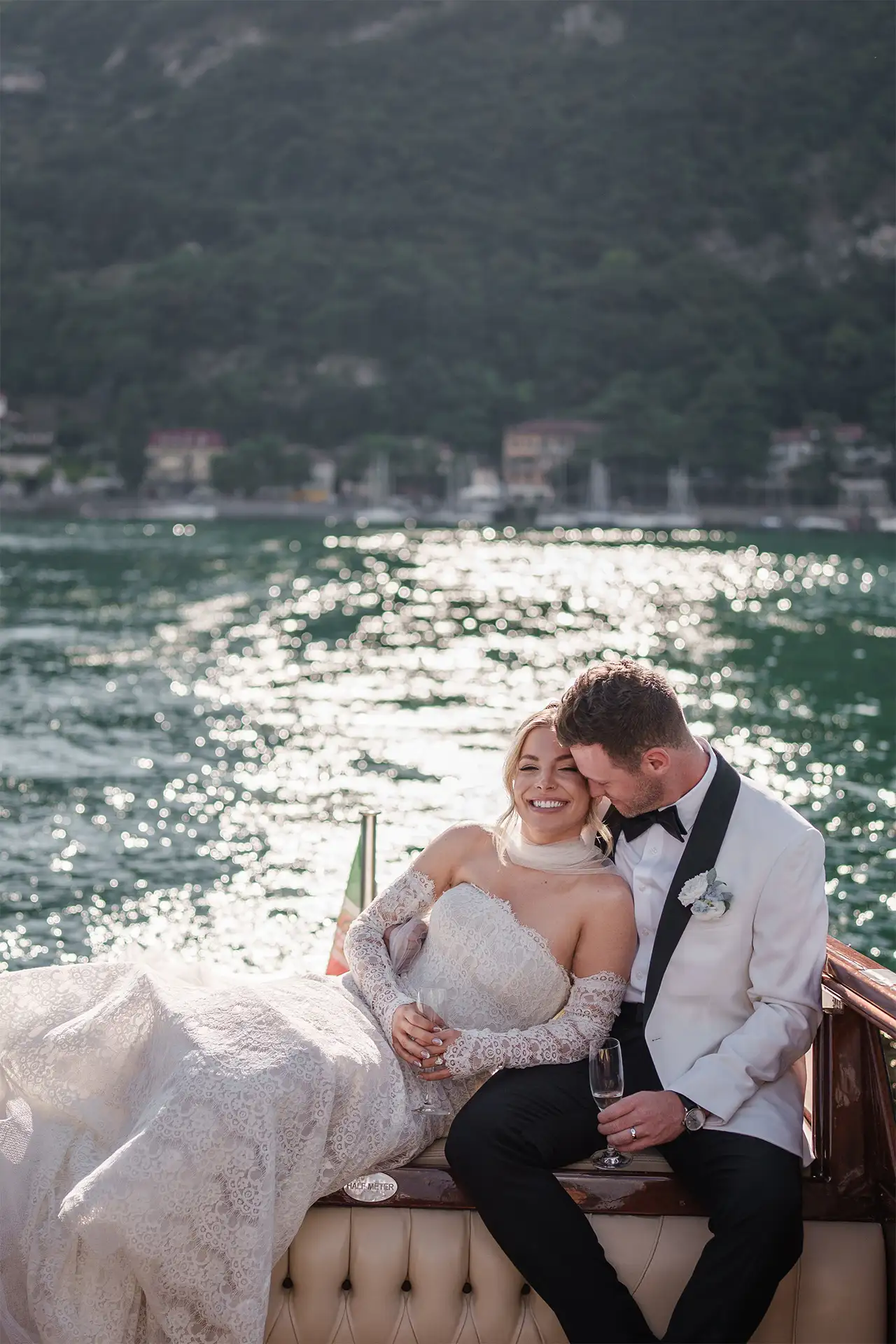 Editorial portrait of bride and groom on a wooden boat on Lake Como