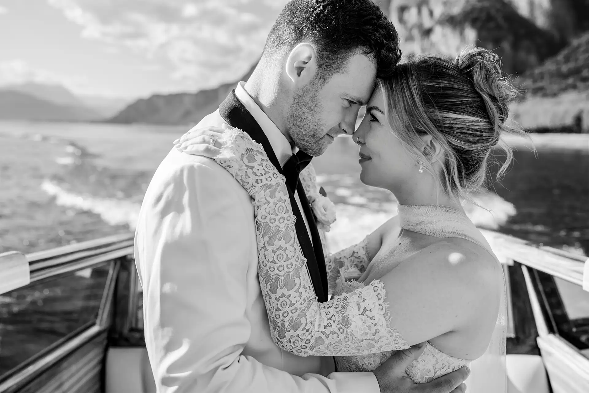 Black and white close portrait of bride and groom on a boat on Lake Como