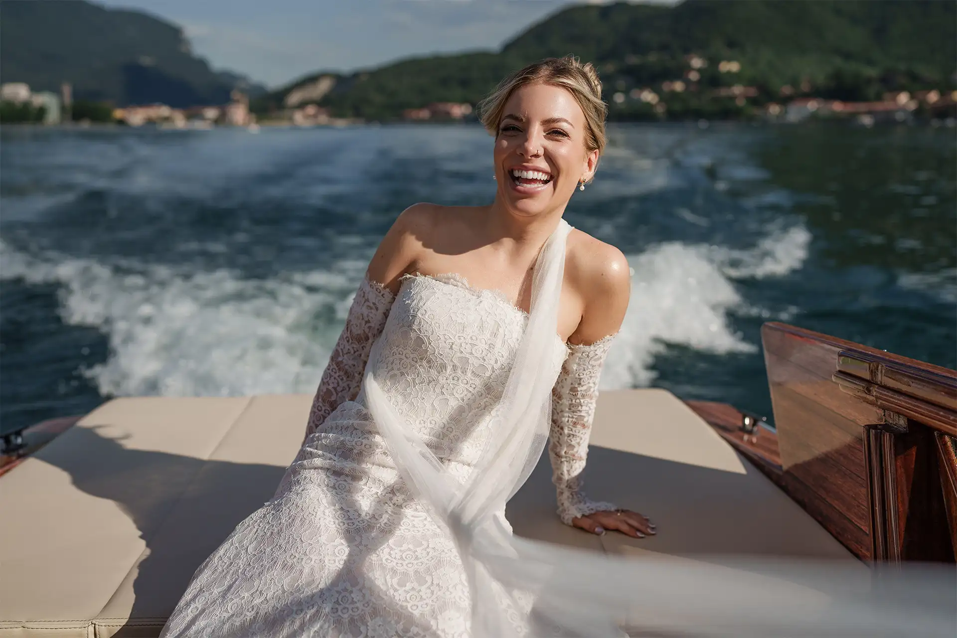 Bride smiling on a wooden boat during a Lake Como wedding