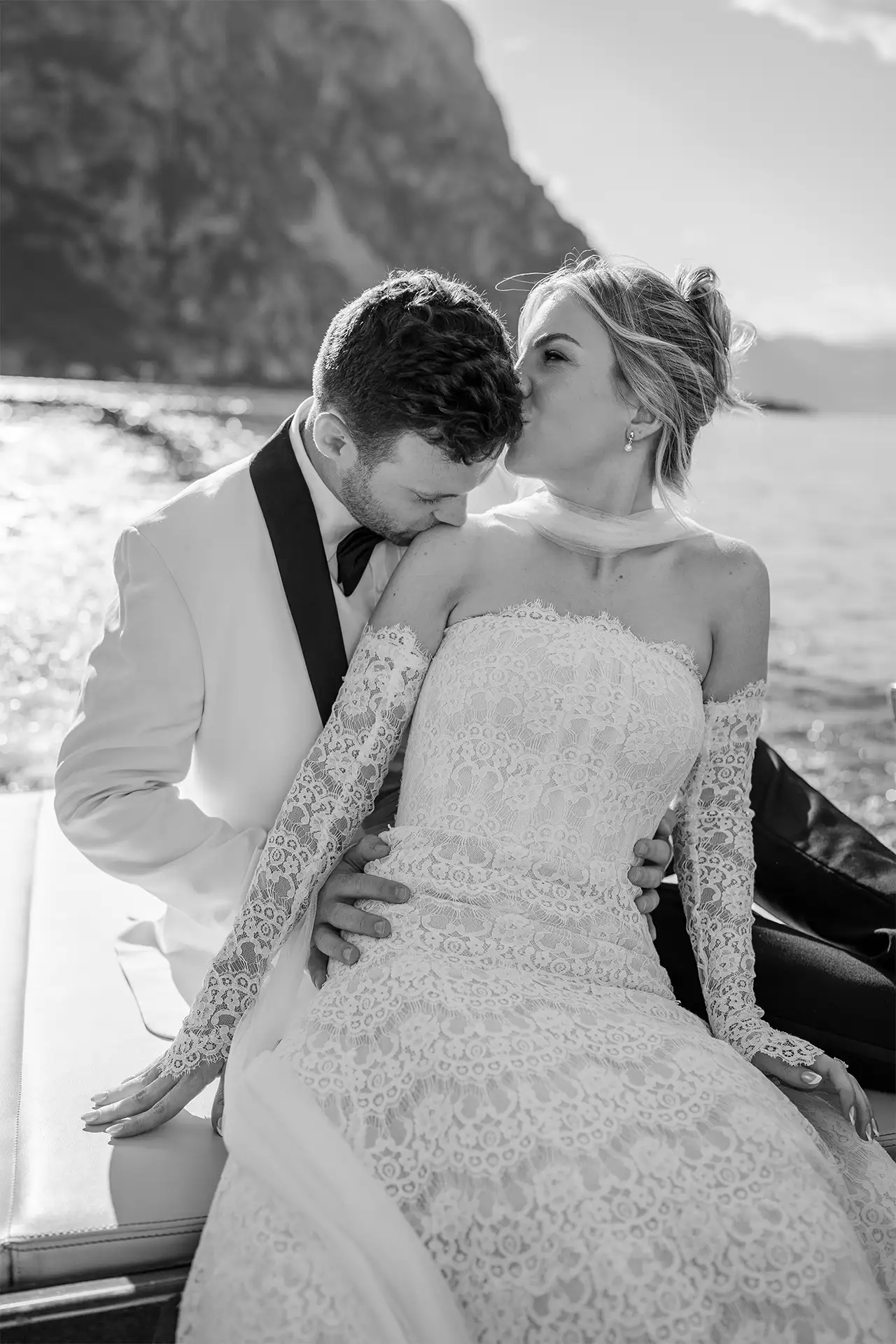 Bride and groom sharing an intimate moment on a boat on Lake Como
