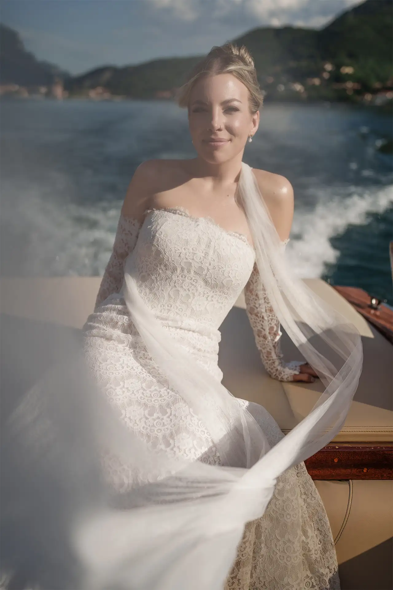 Bride smiling on a boat during a Lake Como wedding portrait session