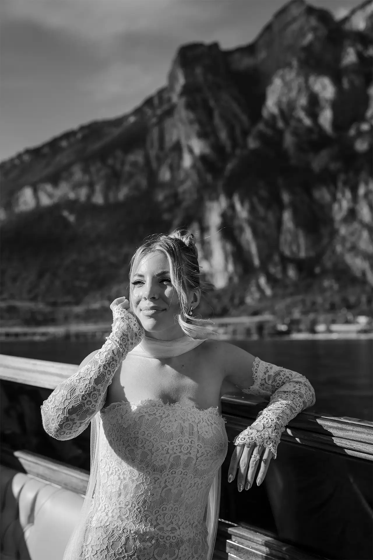 Black and white bridal portrait on a boat with Lake Como mountains behind her