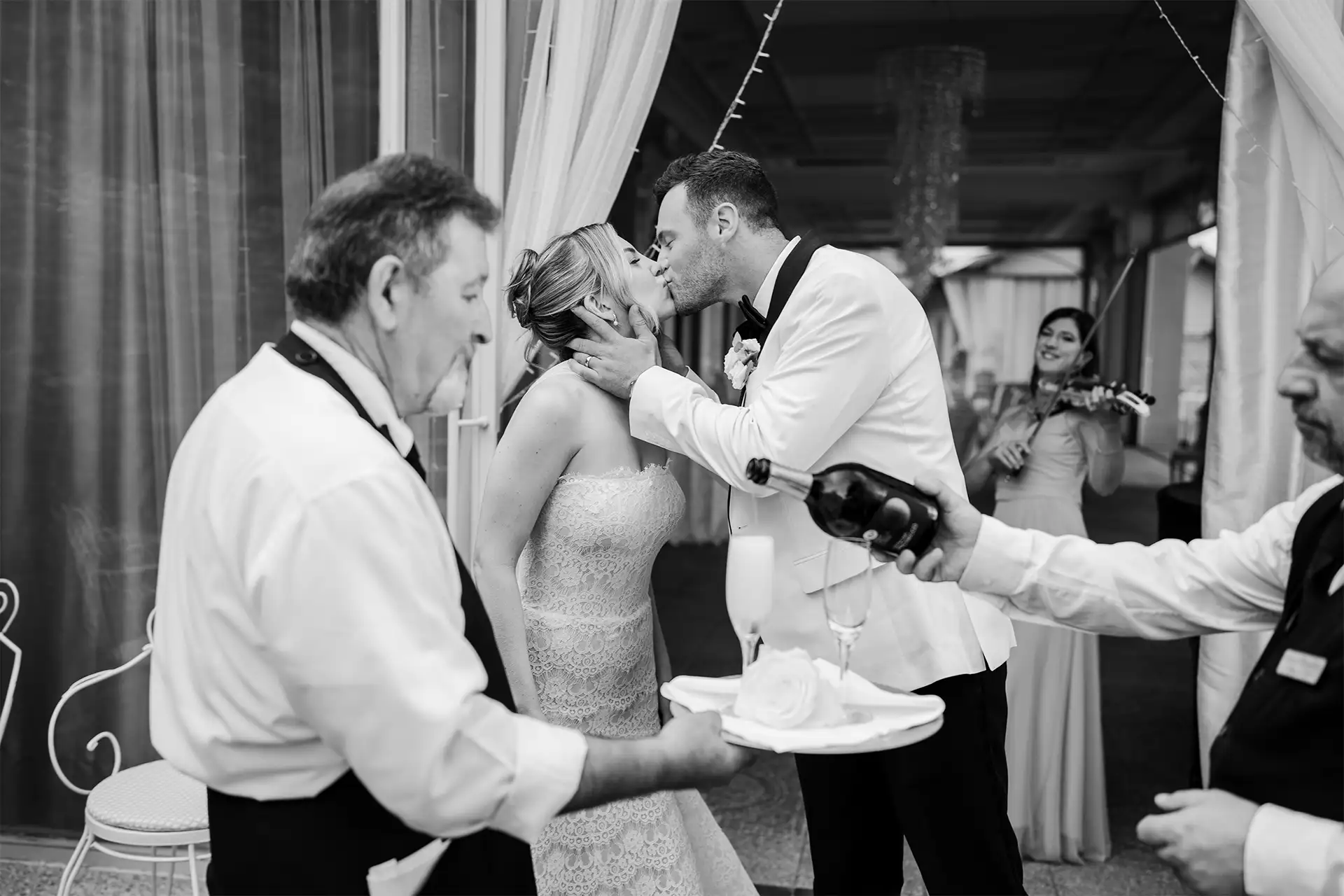 Bride and groom kissing during the wedding reception at Villa Giulia on Lake Como
