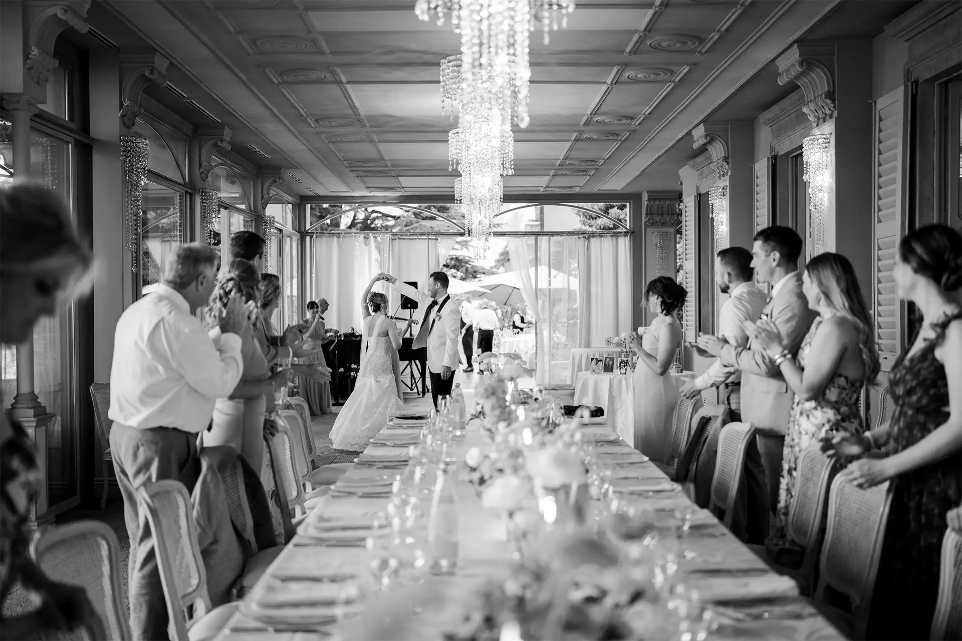 Black and white photo of the newlyweds entering the Villa Giulia wedding reception