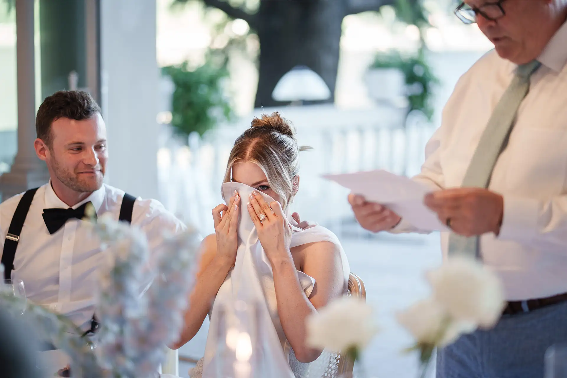 Emotional bride listening to a wedding speech at Villa Giulia