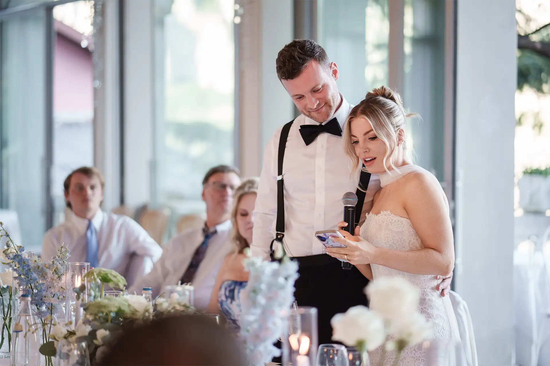 Bride and groom listening to a speech during their Villa Giulia wedding reception