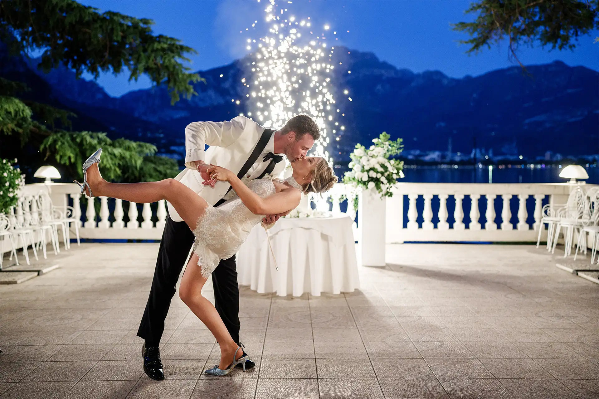 Bride and groom kissing after cutting the wedding cake at Villa Giulia on Lake Como